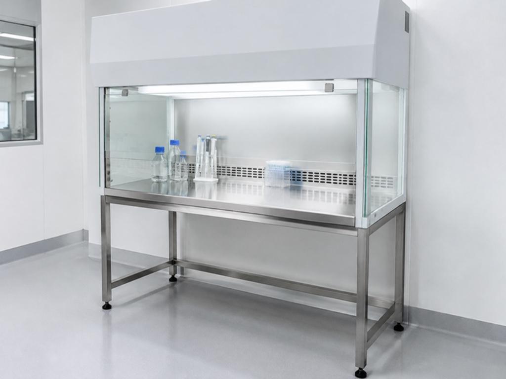 Laminar airflow cabinet with glass sash and side panels on a stainless-steel stand in a cleanroom laboratory