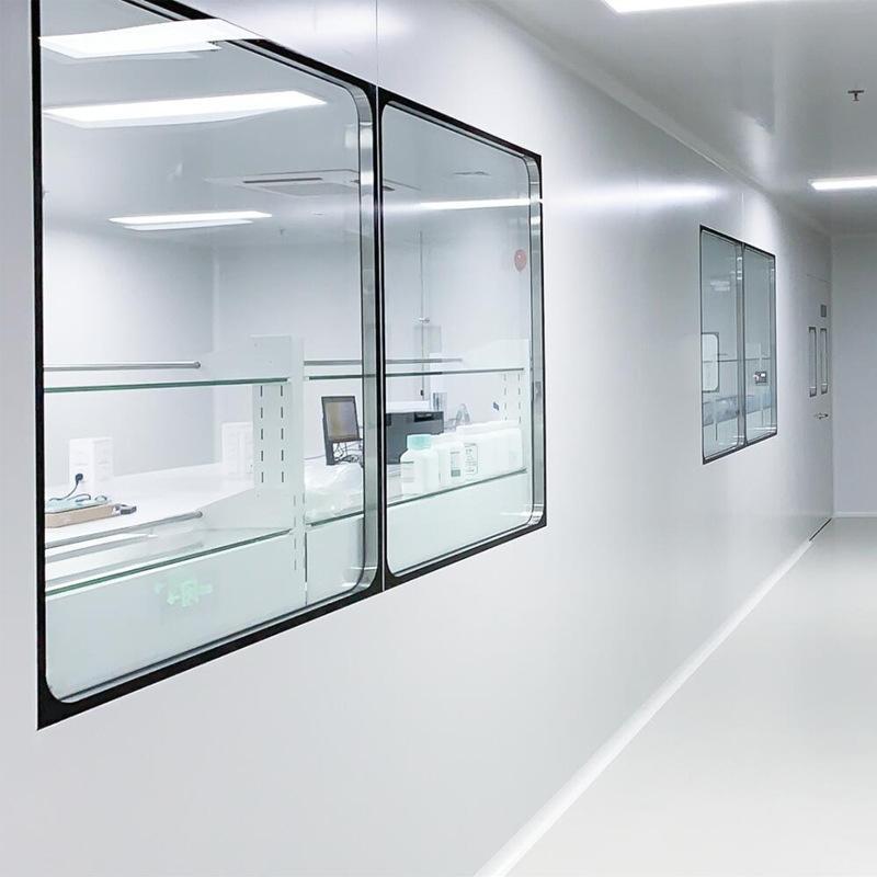 Flush-mounted double-glazed observation window set into a cleanroom partition
