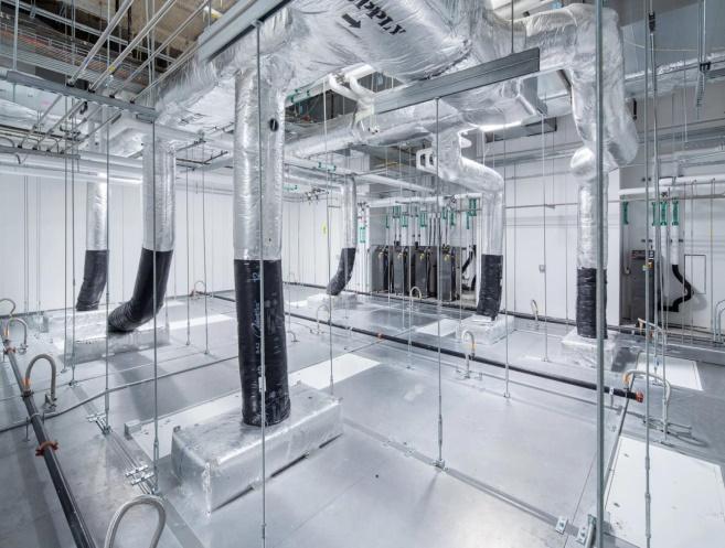 Insulated supply ducting and HEPA terminal drops above an open cleanroom ceiling grid