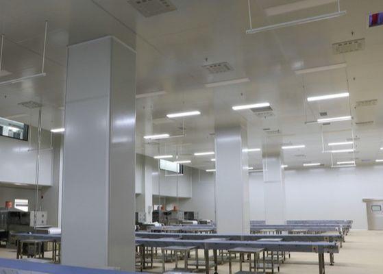 Large controlled hall with panel-clad columns, flush ceiling lighting and stainless-steel benches