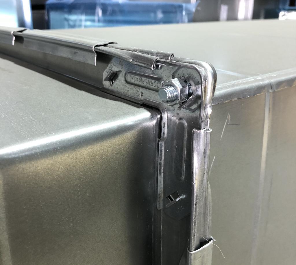Close-up of a galvanised duct corner showing TDF flange and corner-piece construction